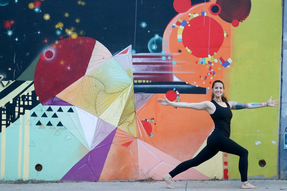 woman in black tank top and black leggings holding yellow umbrella