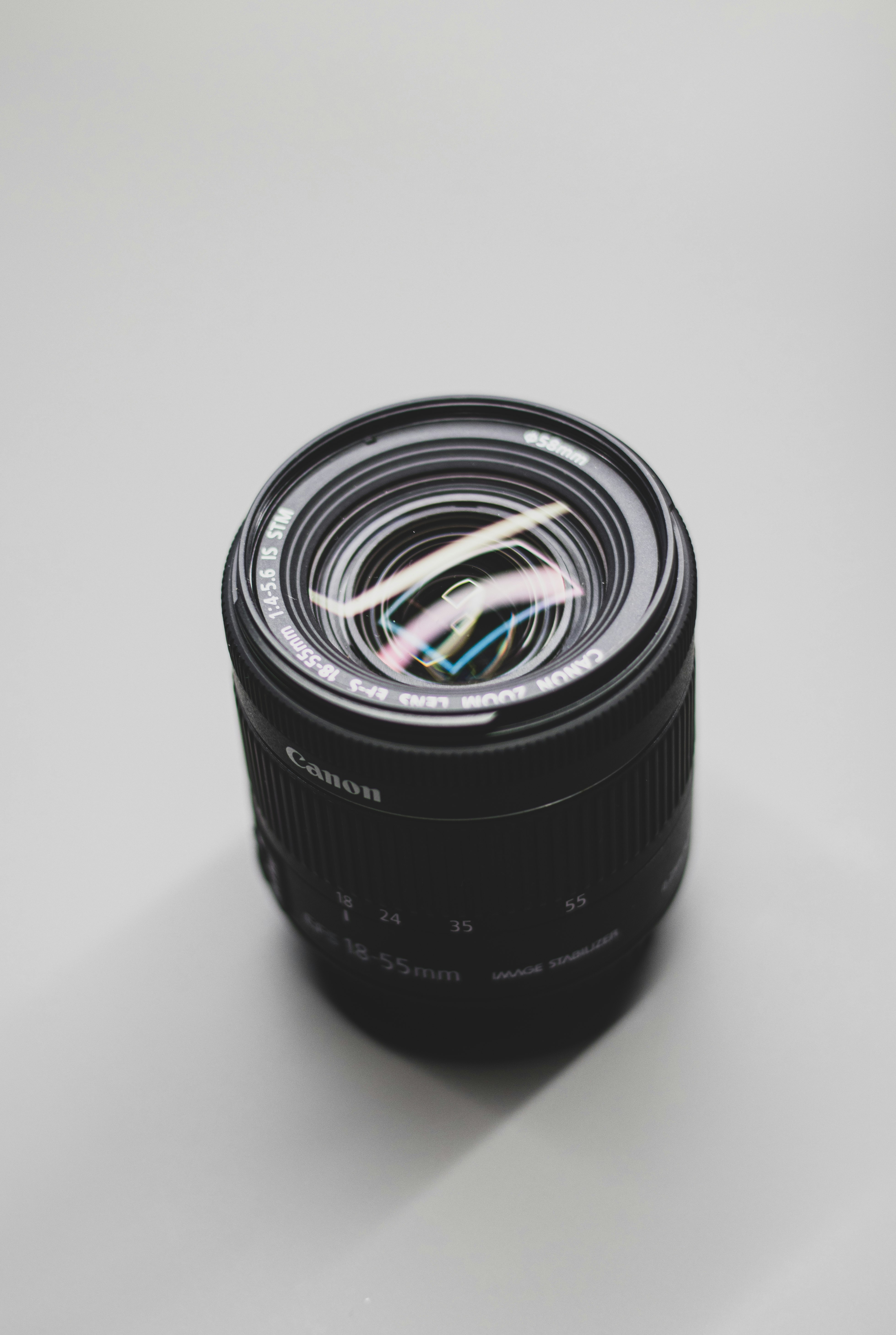 black camera lens on white surface