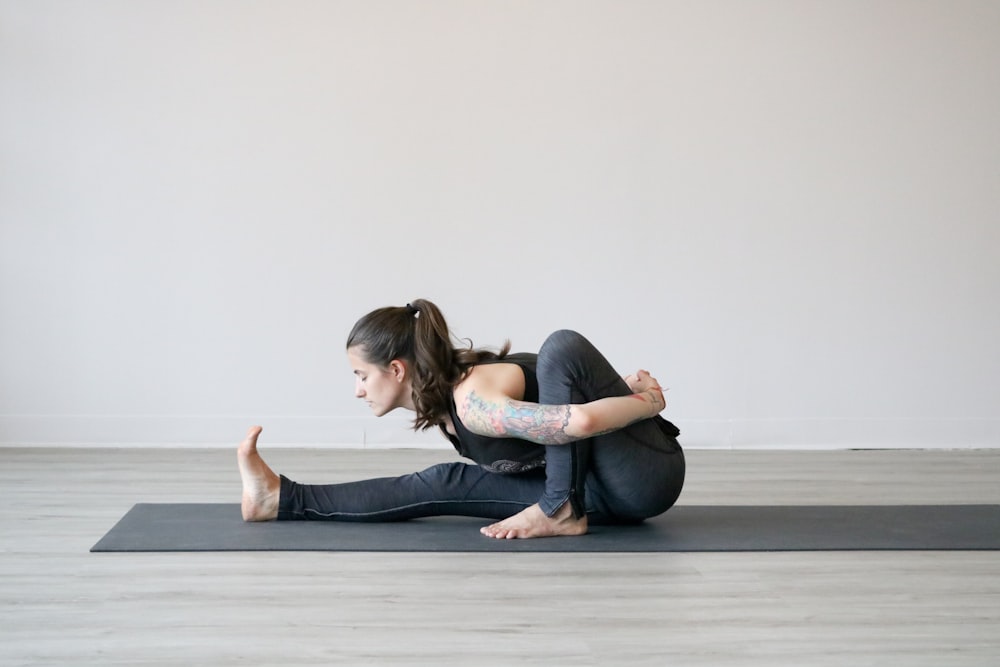 woman in white t-shirt and blue denim jeans lying on floor