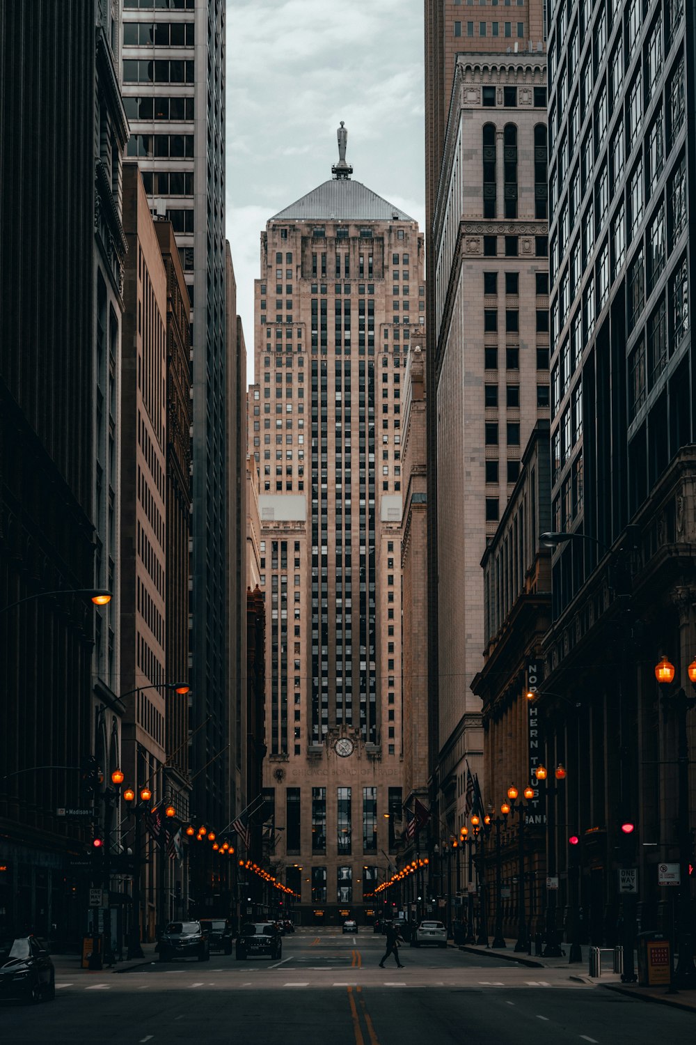 people walking on street between high rise buildings during daytime