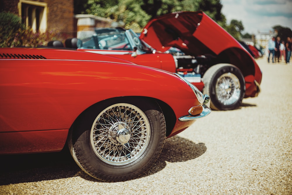 red ferrari car on brown sand during daytime