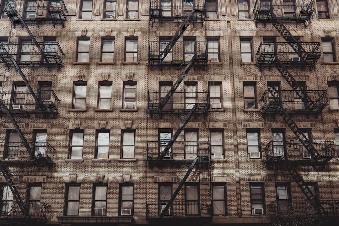 brown concrete building with glass windows, Apartments in Greenwich Village, New York City.<p></figure>See more of Aleks Marinkovic