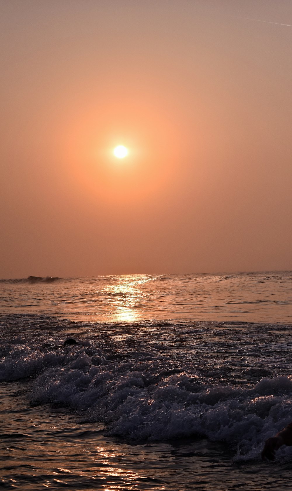 Les vagues de l’océan s’écrasent sur le rivage au coucher du soleil