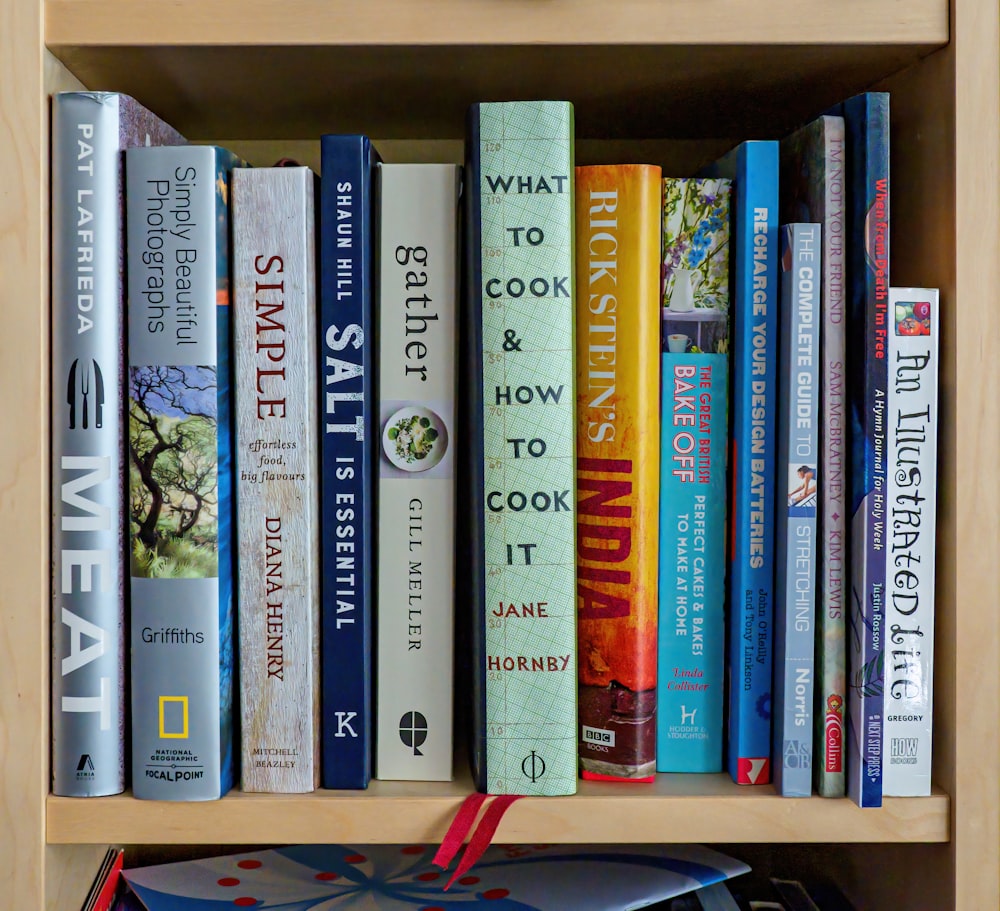 books on brown wooden shelf