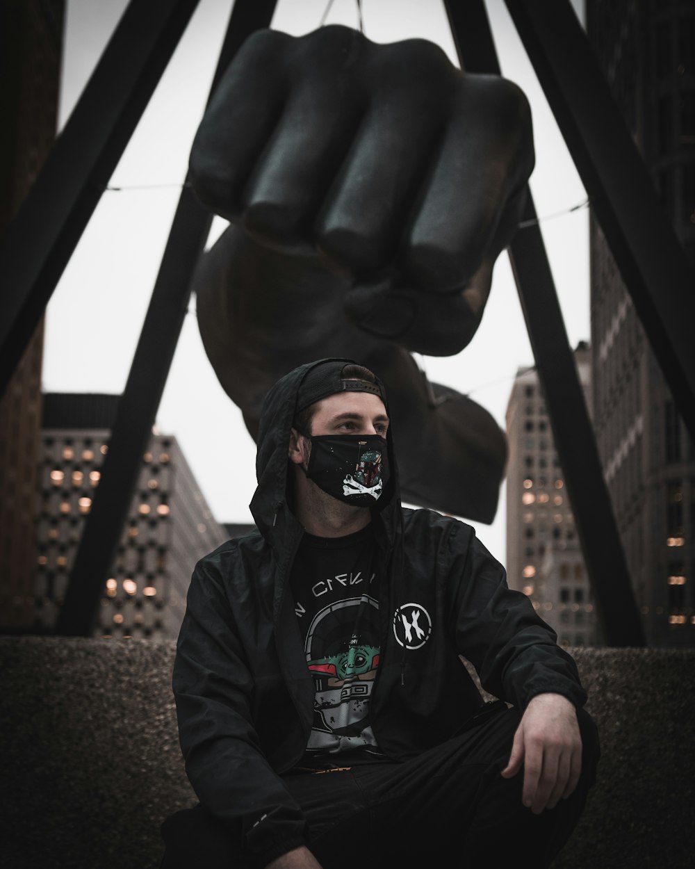 man in black jacket wearing black sunglasses sitting on black leather chair