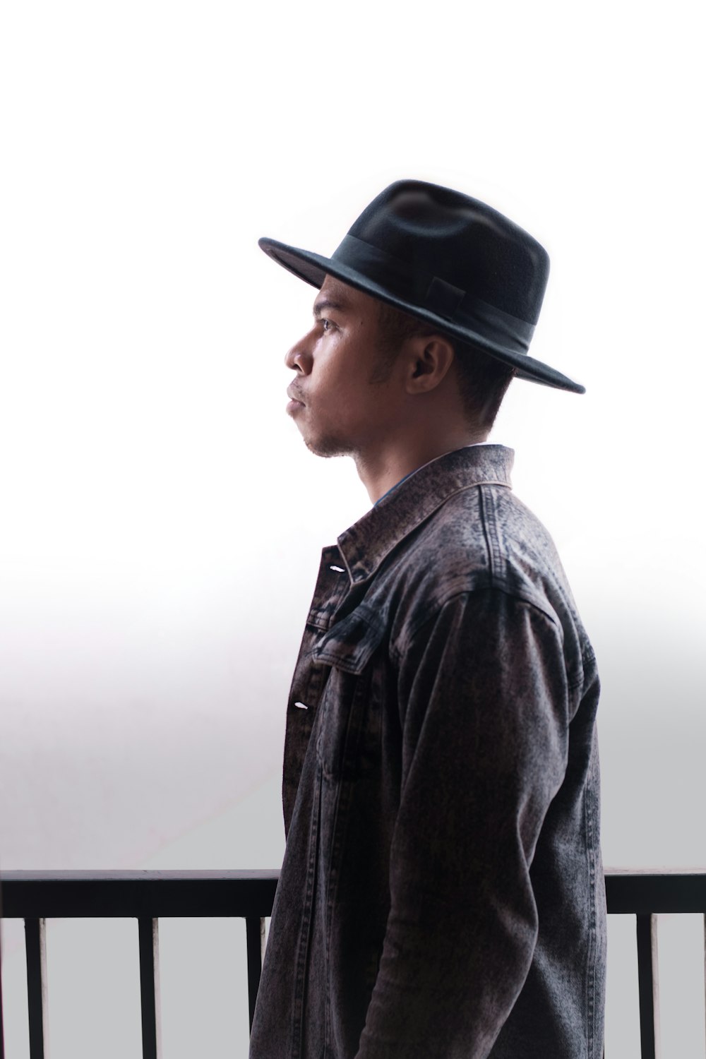 man in black leather jacket and black fedora hat