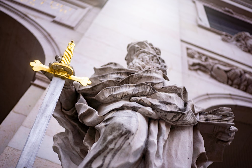 gold cross on gray concrete statue