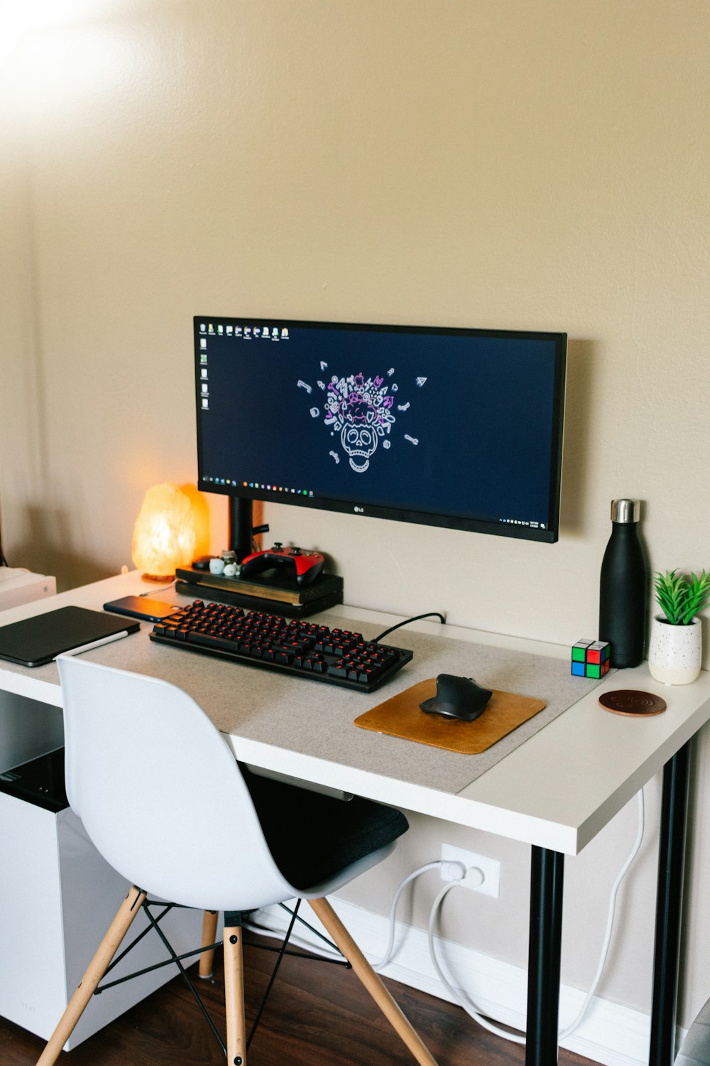 白い木製の机の上に黒いフラットスクリーンコンピューターモニター