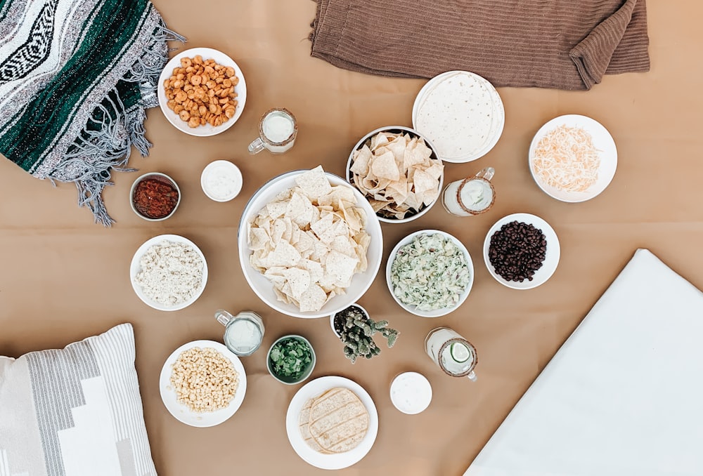 white ceramic bowls on white table cloth