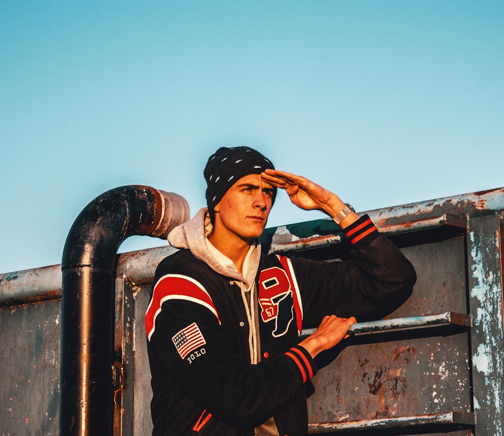 man in black and red jacket wearing black cap