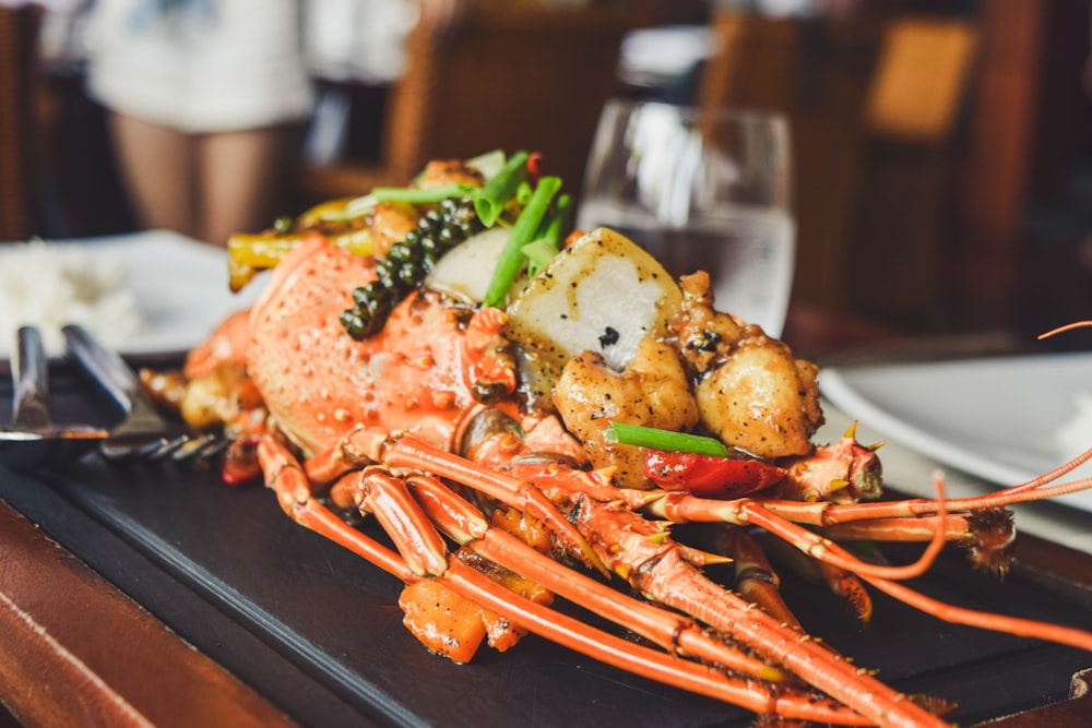 orange and white lobster on black tray