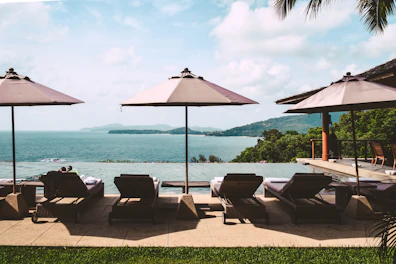 brown and black outdoor table and chairs near sea during daytime