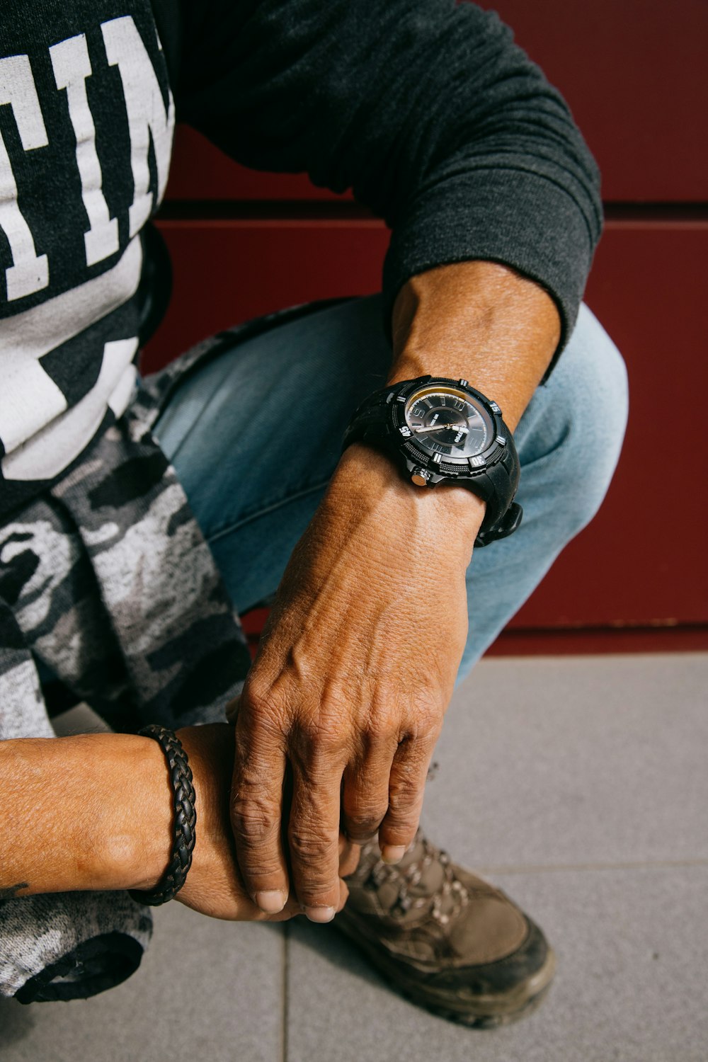 person wearing black and silver round analog watch