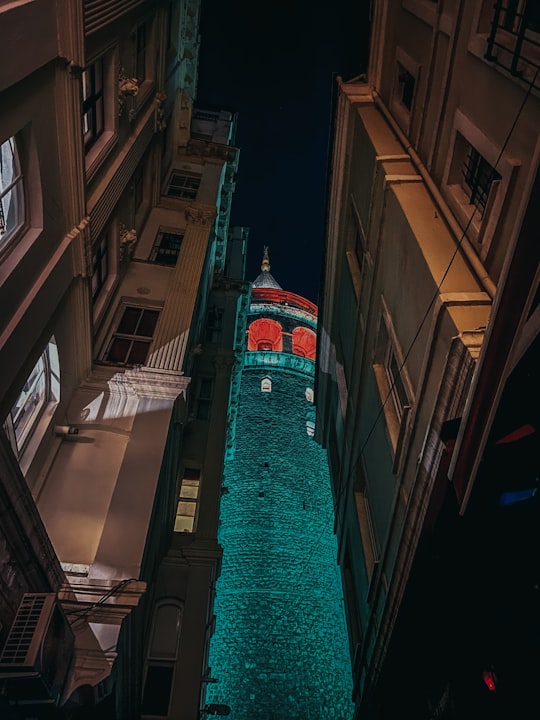 brown concrete building during nighttime in Galata Tower Turkey