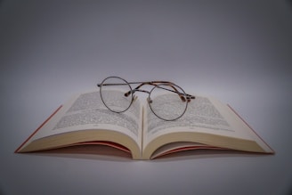 black framed eyeglasses on book page