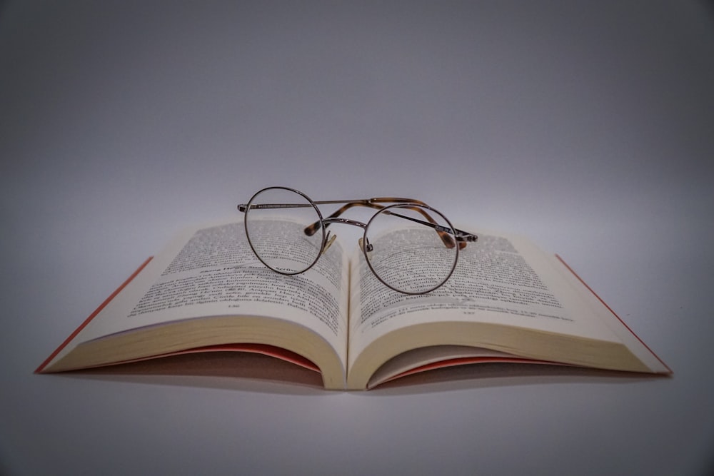 black framed eyeglasses on book page