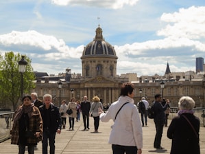 people walking on sidewalk near brown concrete building during daytime