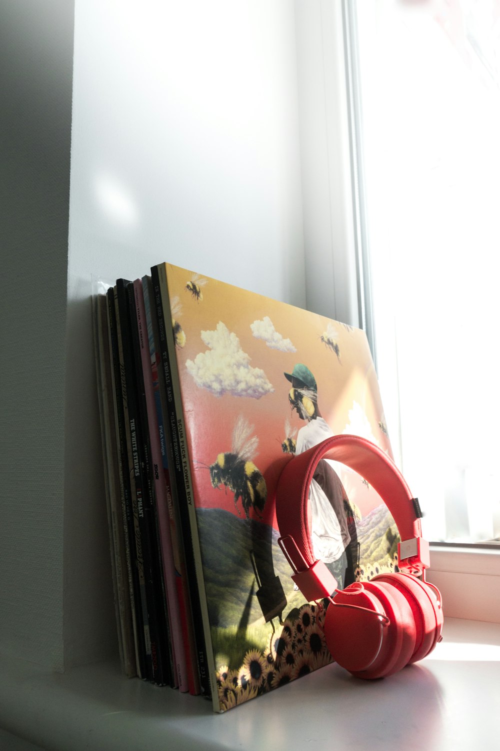 red and white headphones on books
