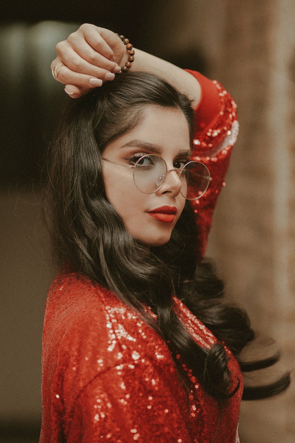 woman in red and white floral scarf wearing silver framed eyeglasses