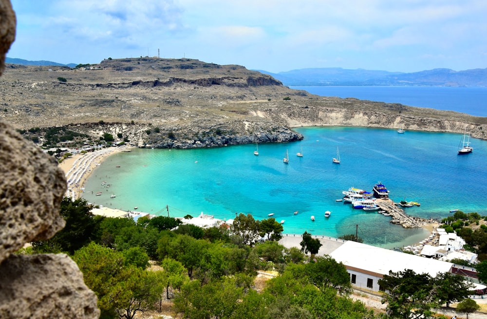 aerial view of white and blue boat on blue sea water during daytime