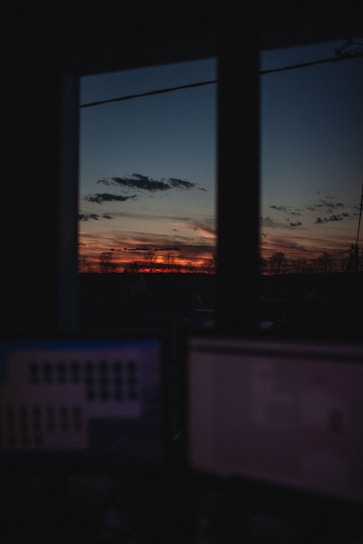 Futuristic dark mode office with glowing orange AI interface screens.