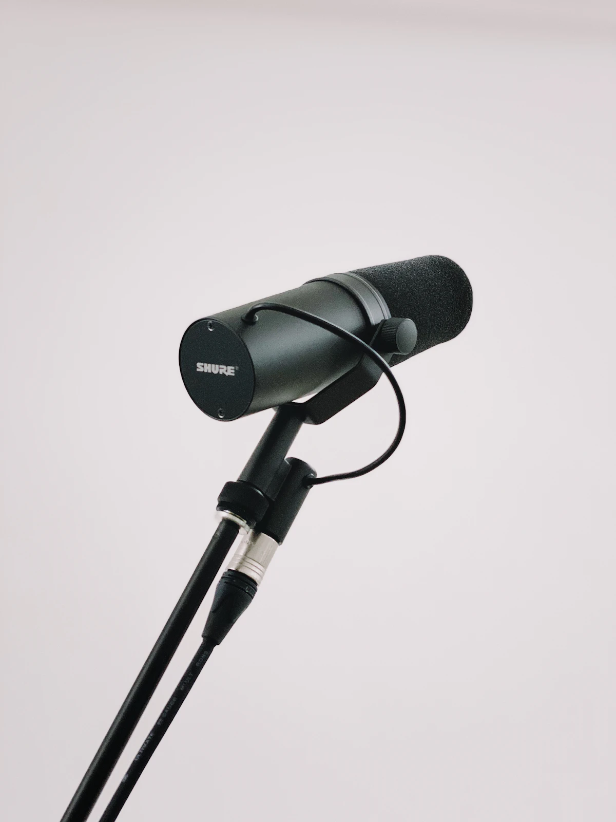 Black podcast microphone on a recording stand