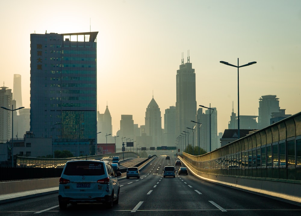 cars on road near city buildings during daytime