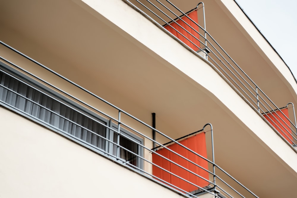 white concrete staircase with red metal railings