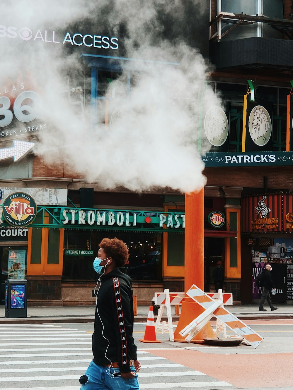 man in black jacket standing near store