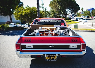 red chevrolet camaro on road during daytime