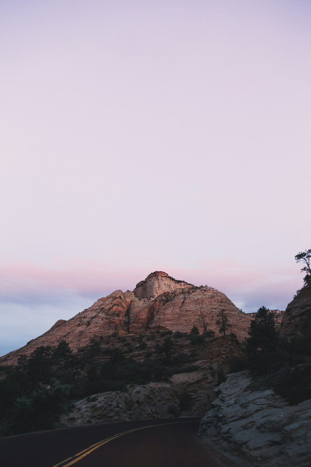 person standing on brown rock formation during daytime