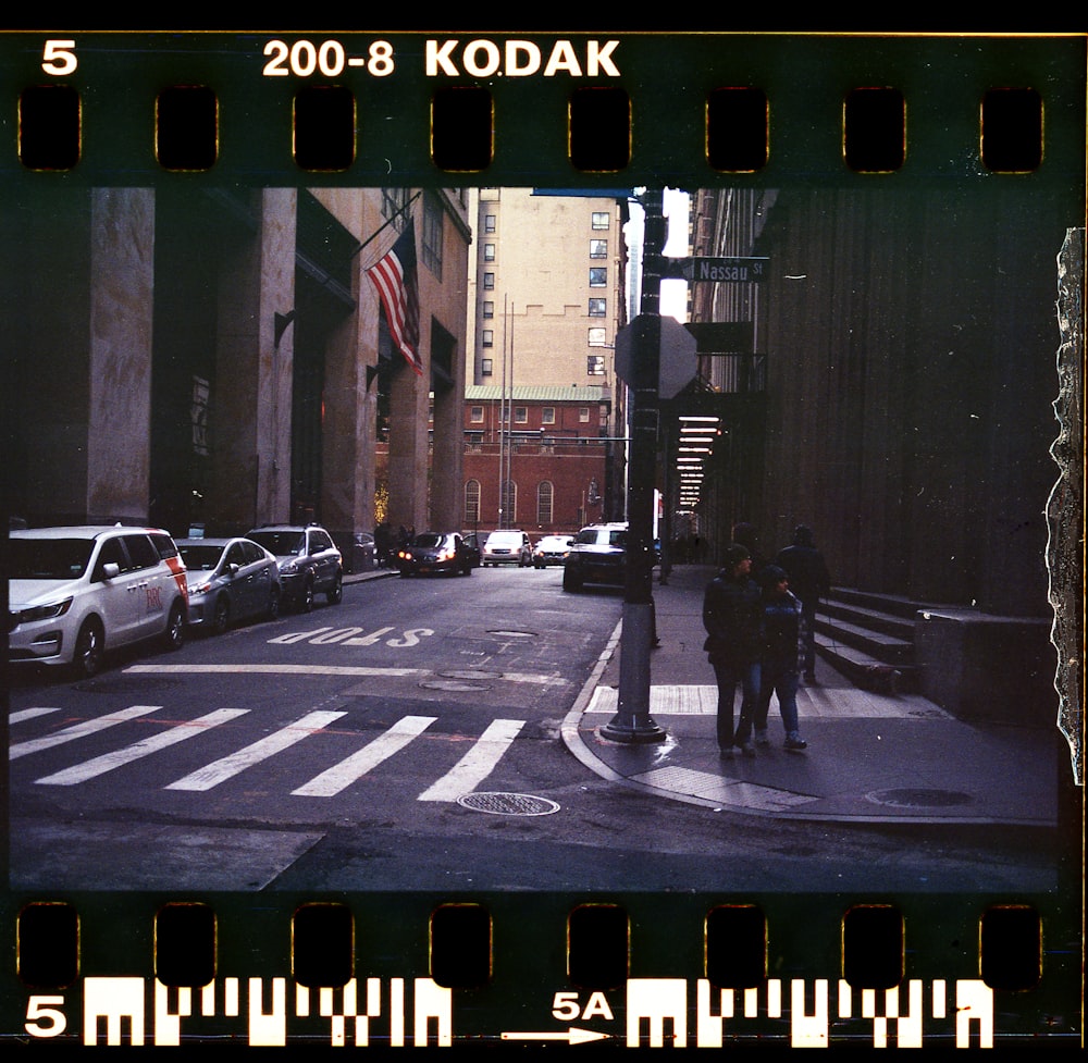 man in black jacket walking on sidewalk during daytime