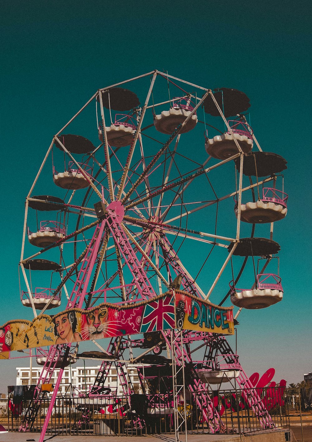 a ferris wheel sitting in the middle of a field