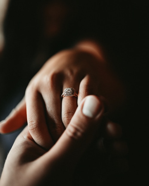 person wearing silver diamond ring