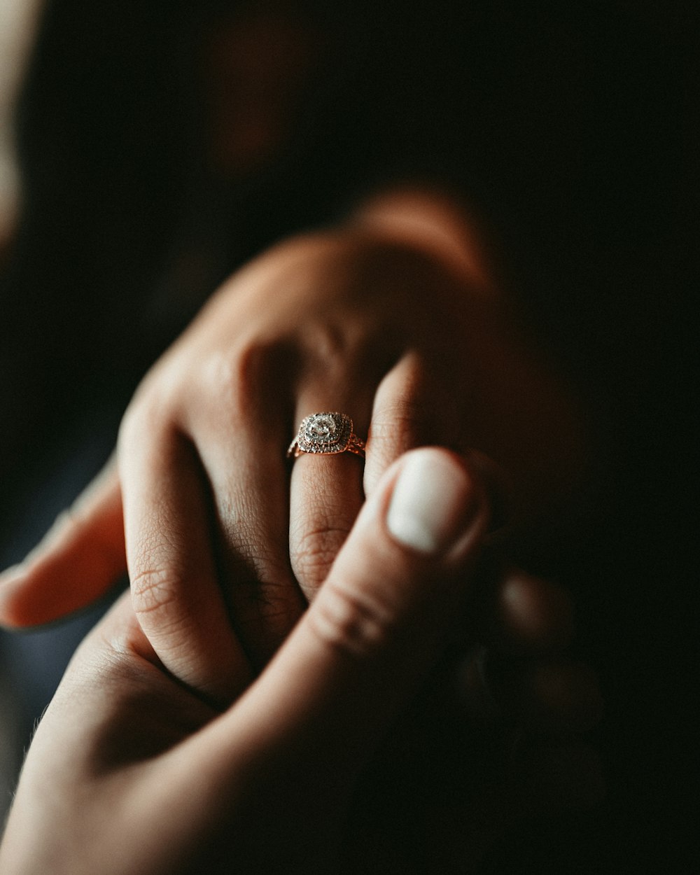 person wearing silver diamond ring