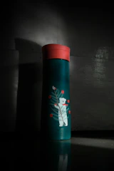 red and white floral bottle