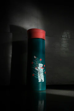 red and white floral bottle