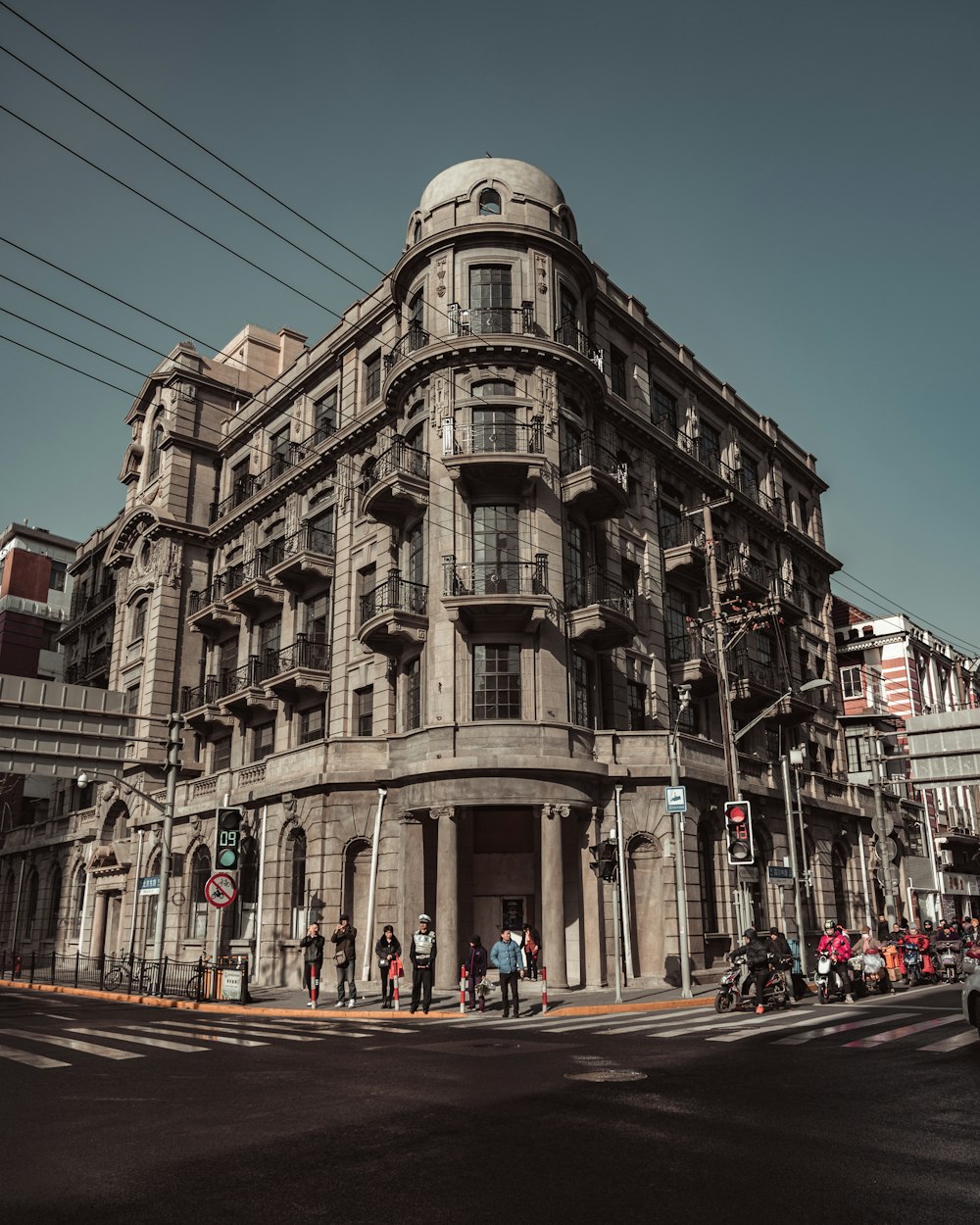 cars parked in front of brown concrete building during daytime