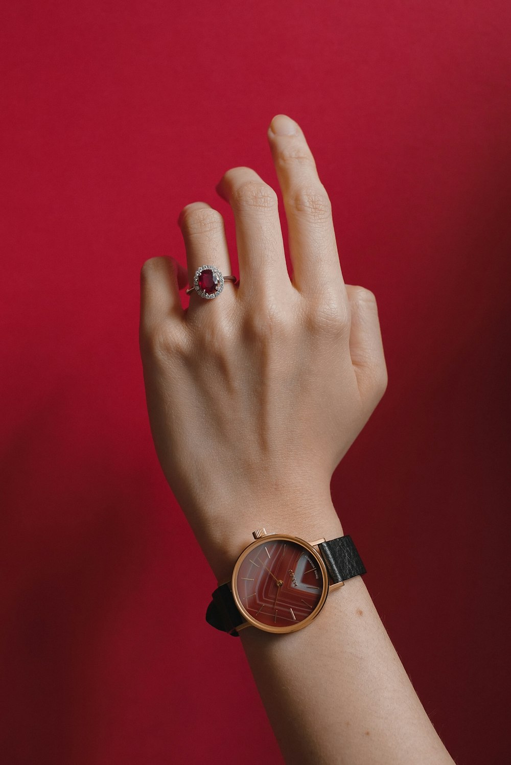 person wearing gold and black analog watch