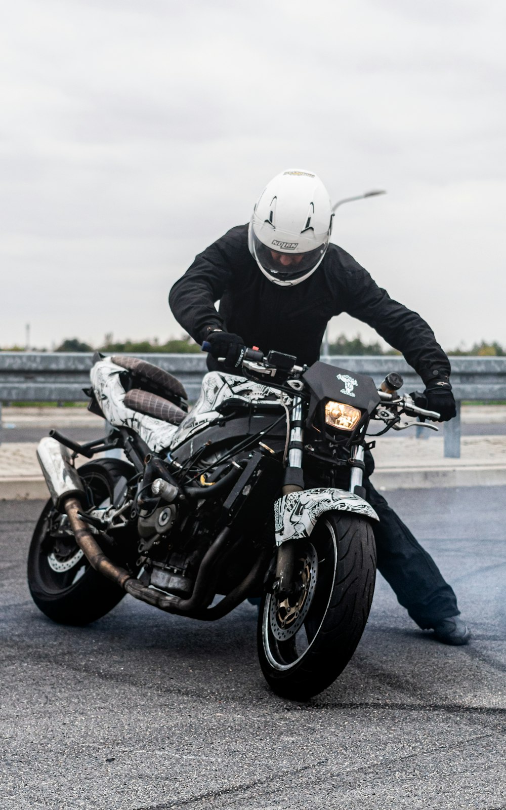 man in black leather jacket riding black motorcycle