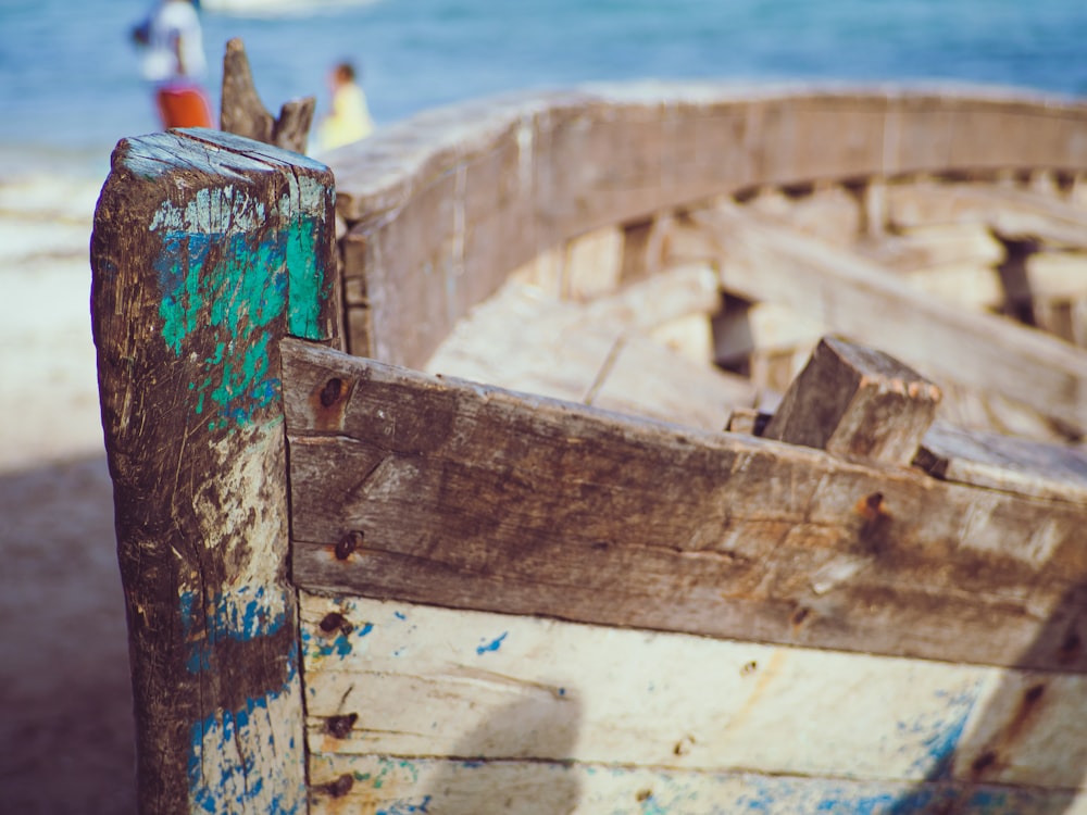 brown wooden boat on sea shore during daytime