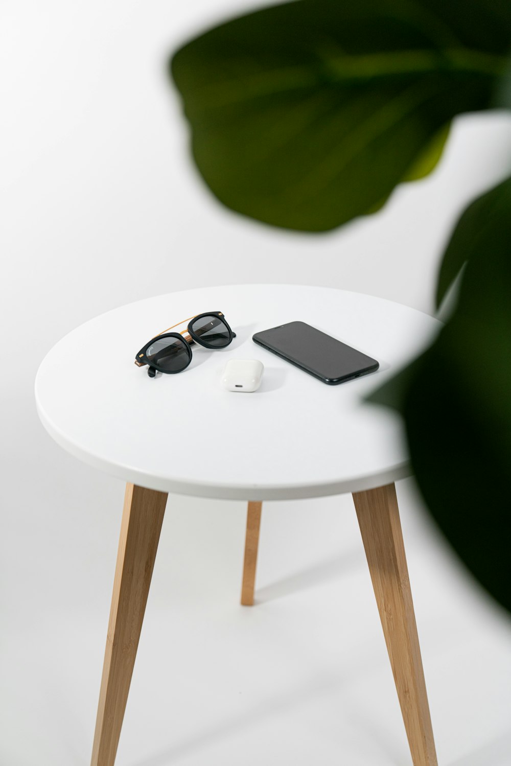 black sunglasses on white table