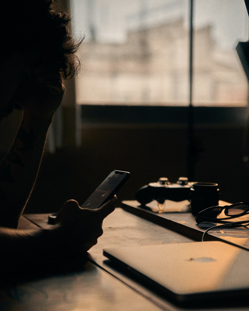 grayscale photo of woman holding smartphone