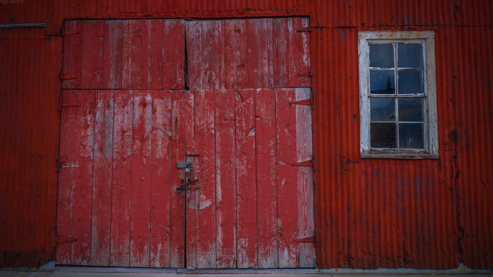red wooden door with black steel door lever