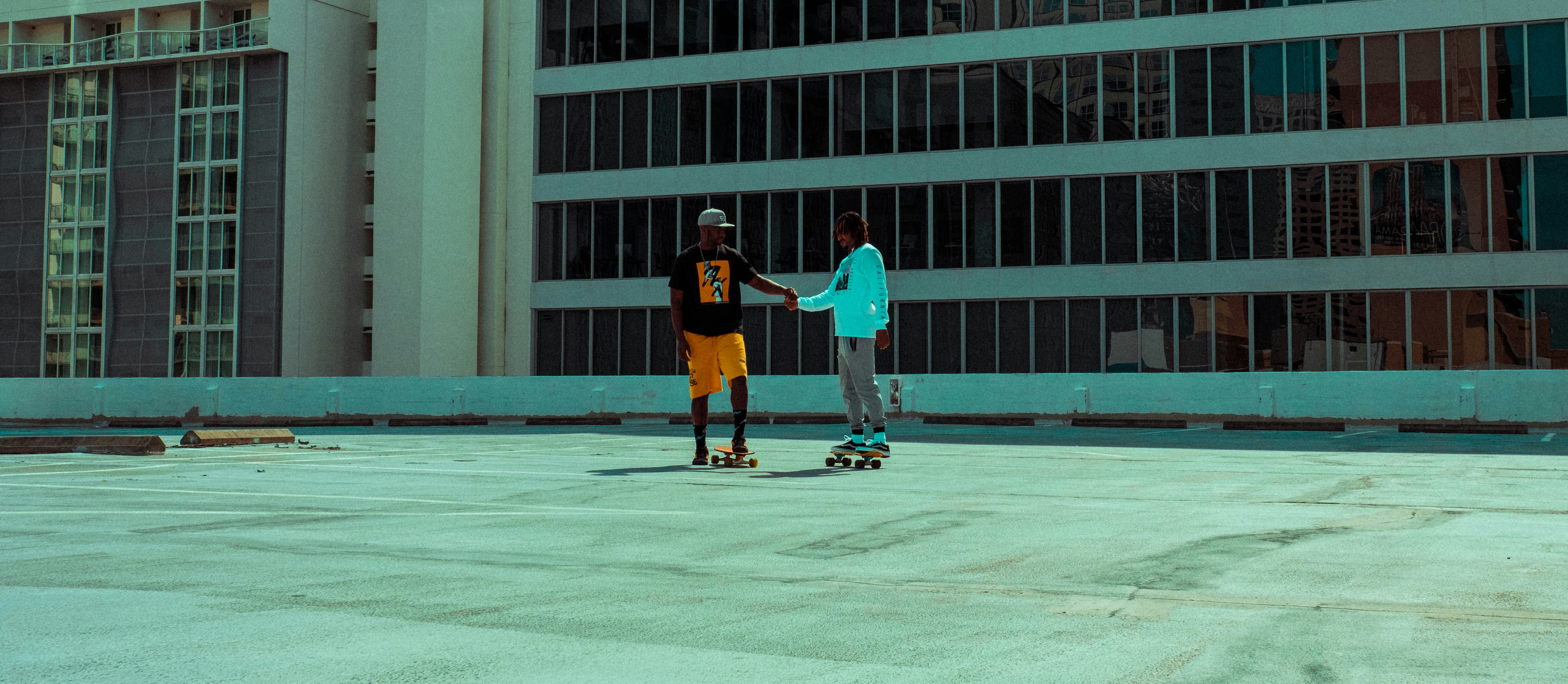 man in black t-shirt and blue denim jeans standing on blue basketball court