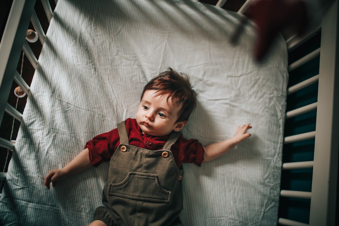 girl in red button up shirt lying on bed