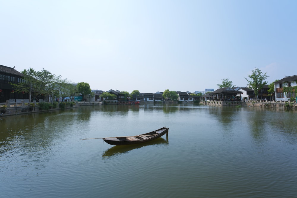 brown boat on body of water during daytime