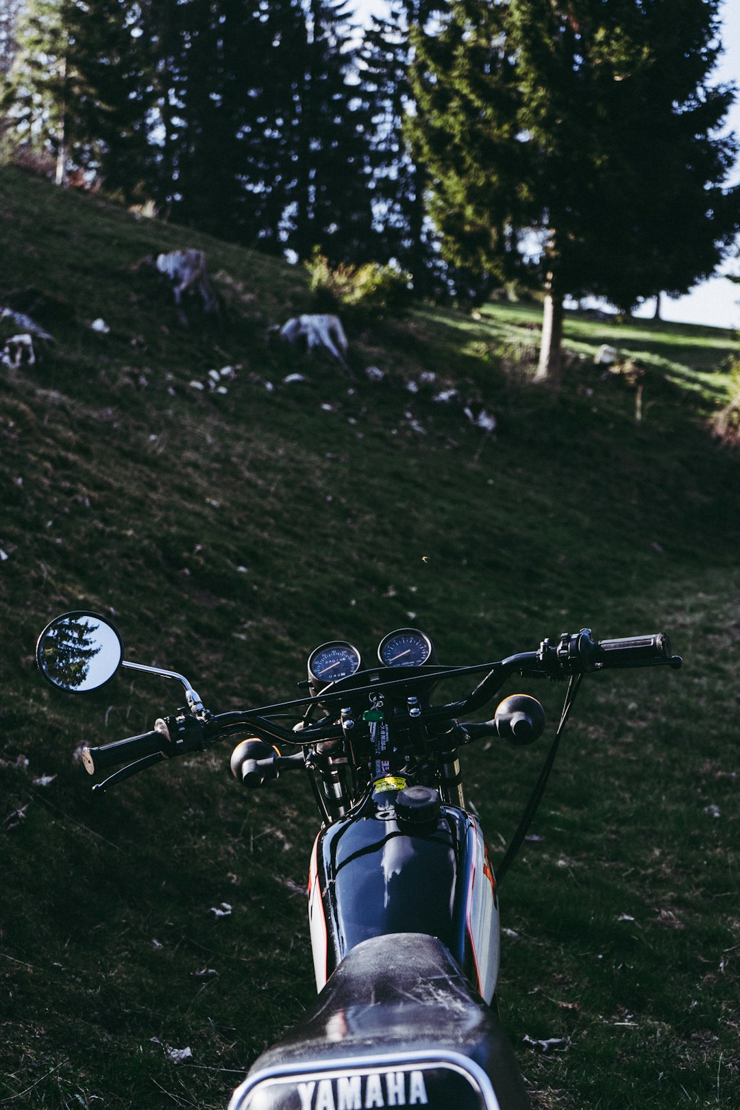 black motorcycle on green grass field during daytime