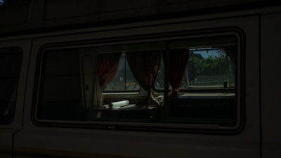 Close-up of a vehicle inspection certificate displayed inside a camper van.