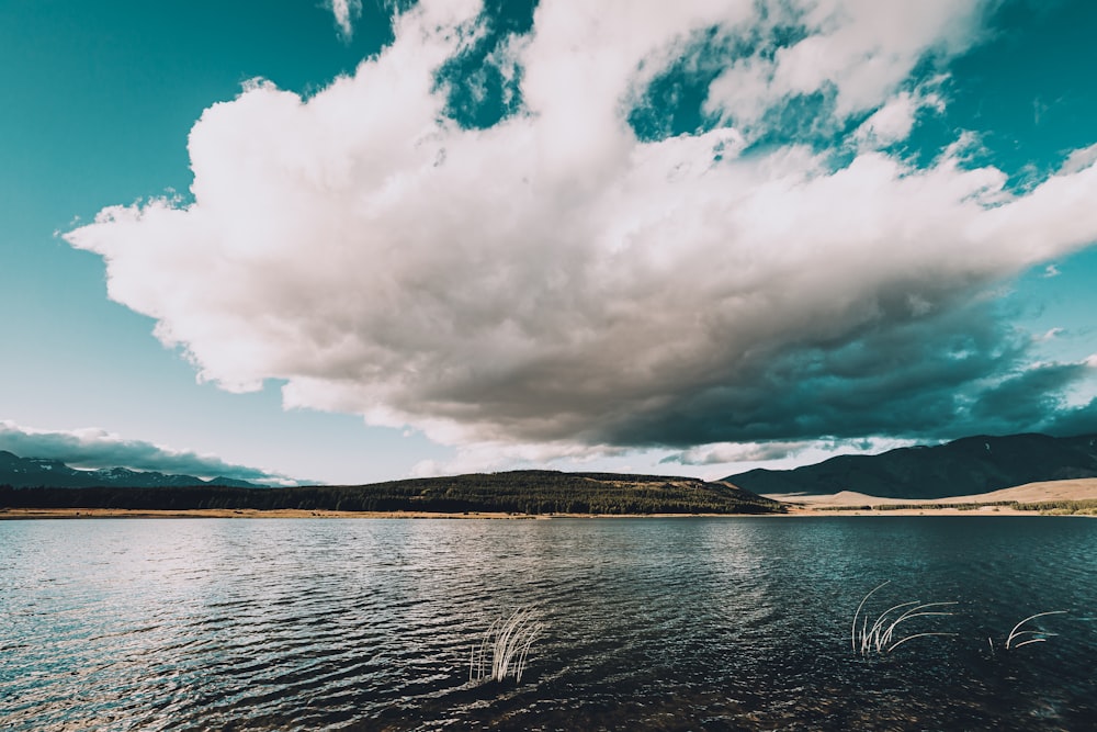 body of water under cloudy sky during daytime